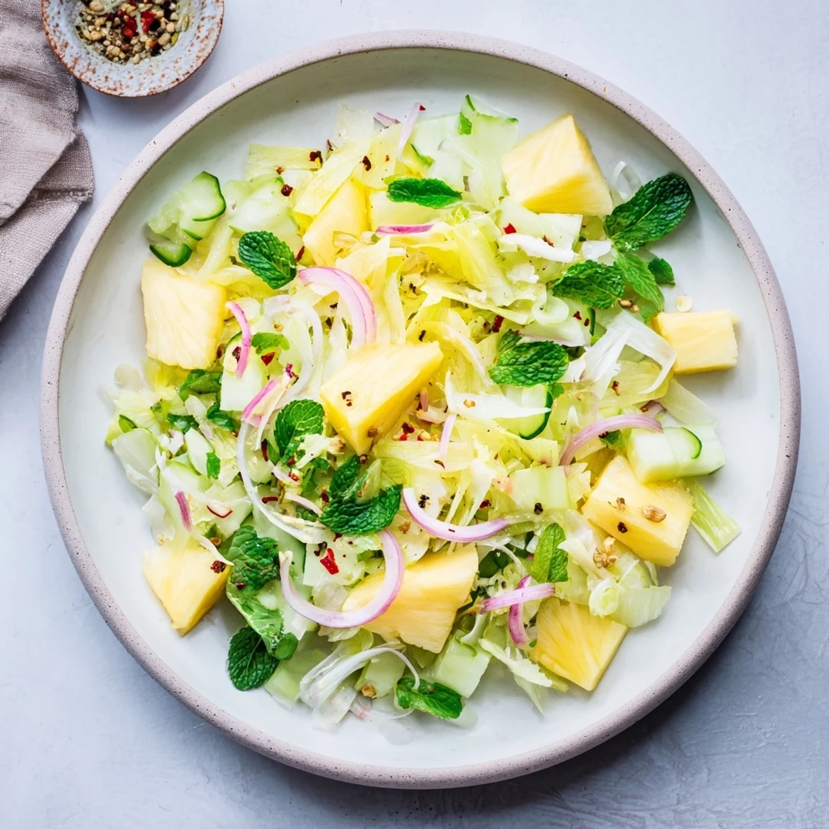 Vibrant Viral Pineapple & Cucumber Salad: a refreshing bowl of sweet pineapple and crisp cucumber, ready to serve.