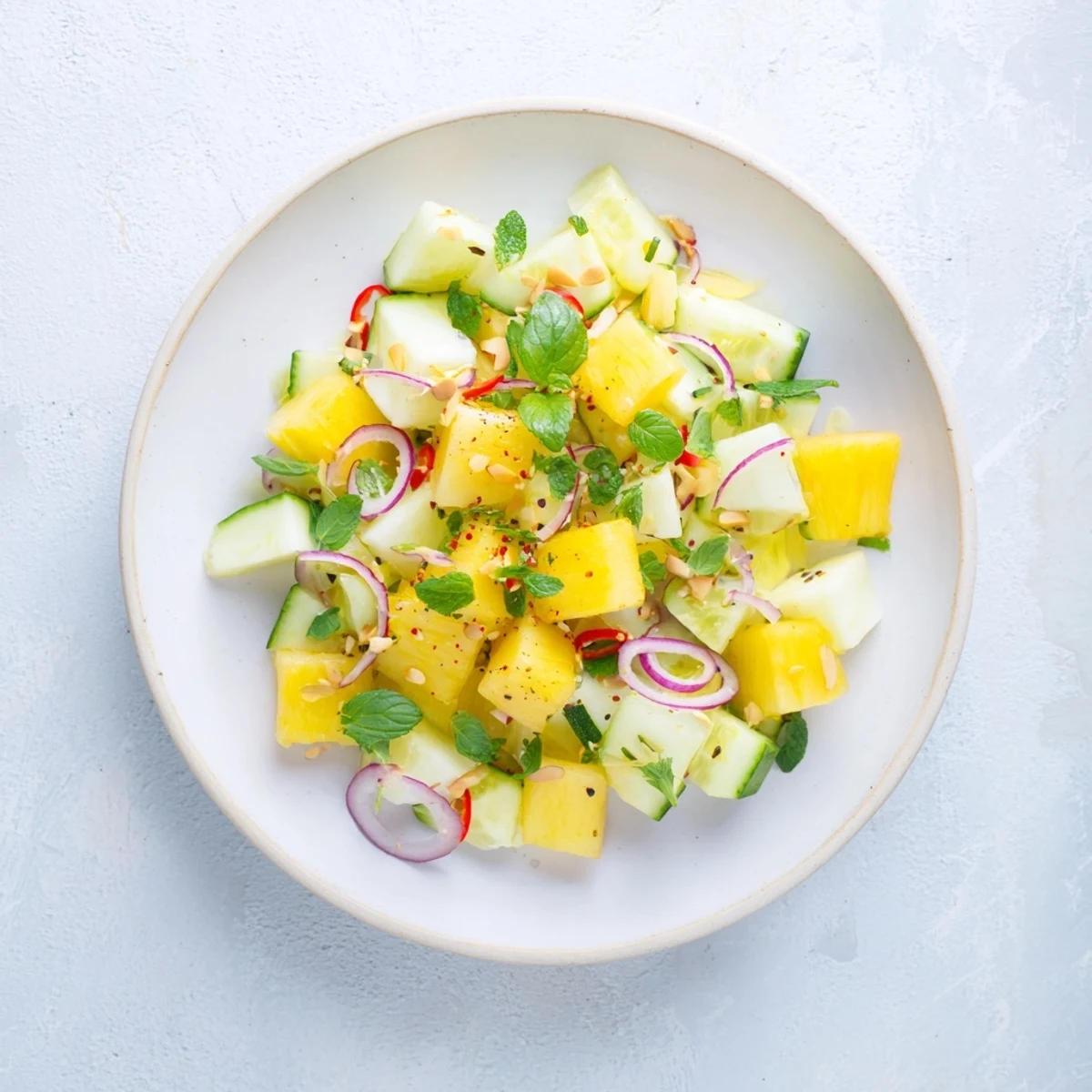 Freshly tossed Viral Pineapple & Cucumber Salad; cubed pineapple with cucumber and red onion, ready for a taste.
