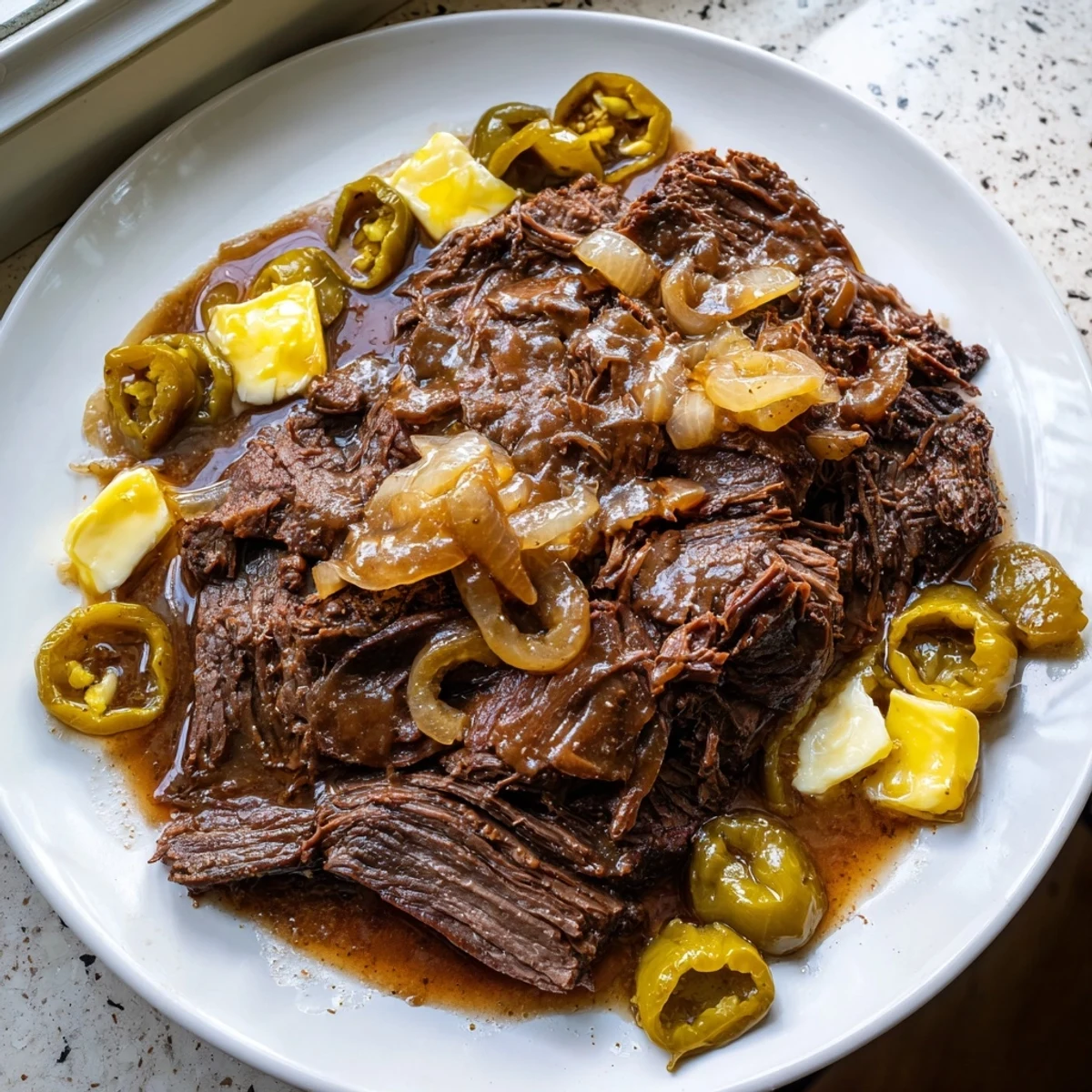 Close-up of bubbling Instant Pot Zippy Mississippi Pot Roast, rich with pepperoncini and savory gravy.