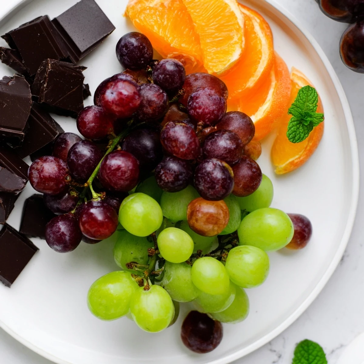 A beautiful Grapes of Fortune Dessert Board, showcasing festive grapes, cheeses, and tempting sweets.