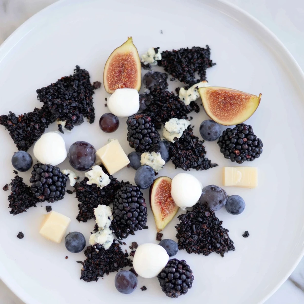 This Deep Indigo Midnight Sky cheese board recipe offers a beautiful arrangement of dark fruits and cheeses.