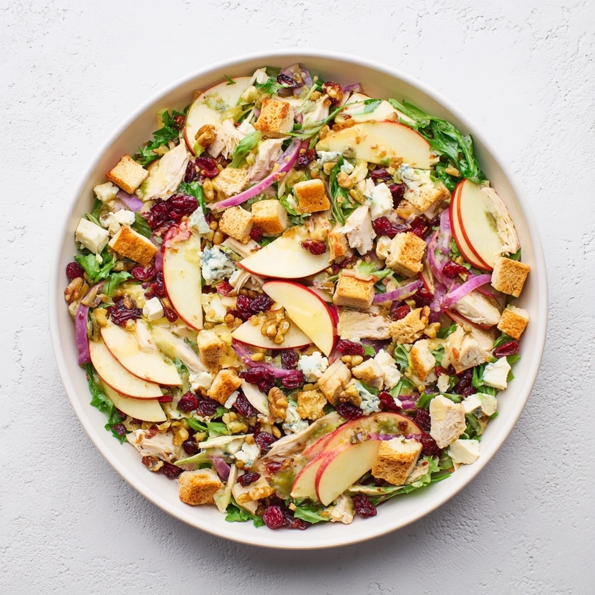 Chicken and Apple Winter Salad, a colorful mix of apples, chicken, and pecans, looks fresh and inviting.