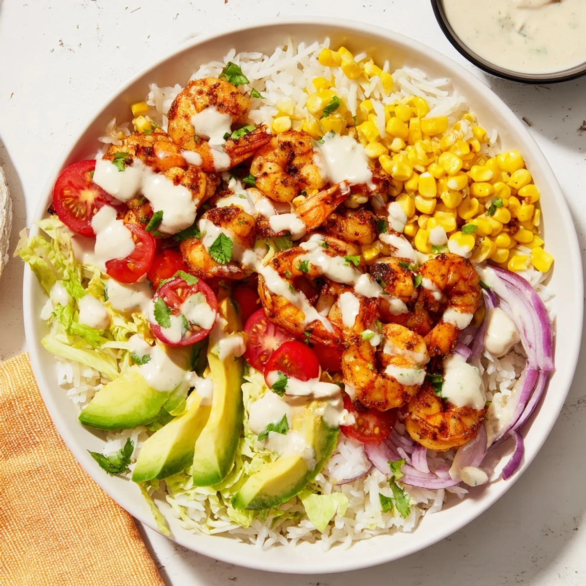 Tempting Cajun Shrimp Taco Bowls, overflowing with colorful veggies, flavorful shrimp, and creamy sauce, ready to enjoy.