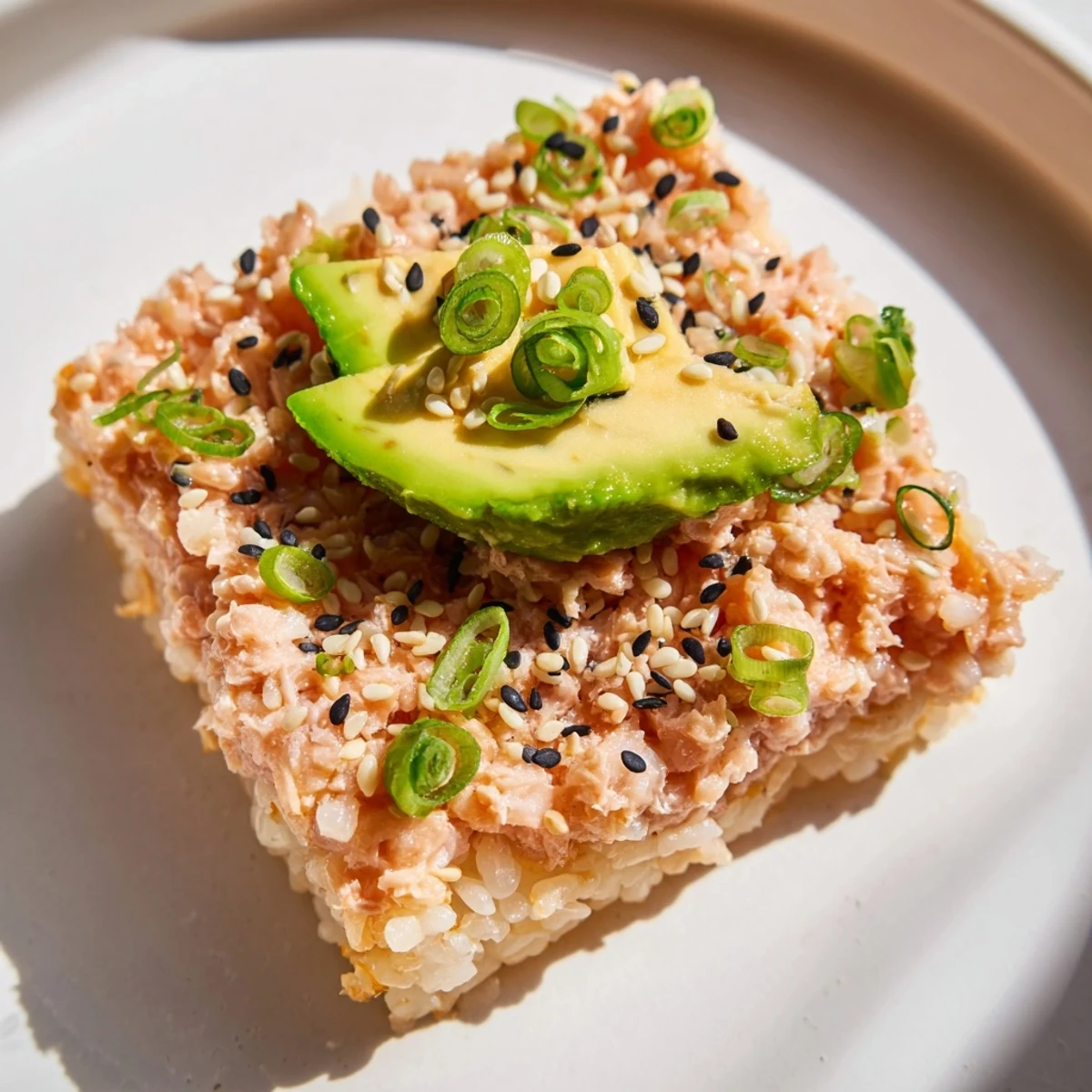 A close-up of delicious Spicy Tuna Crispy Rice: perfectly fried rice topped with creamy tuna.