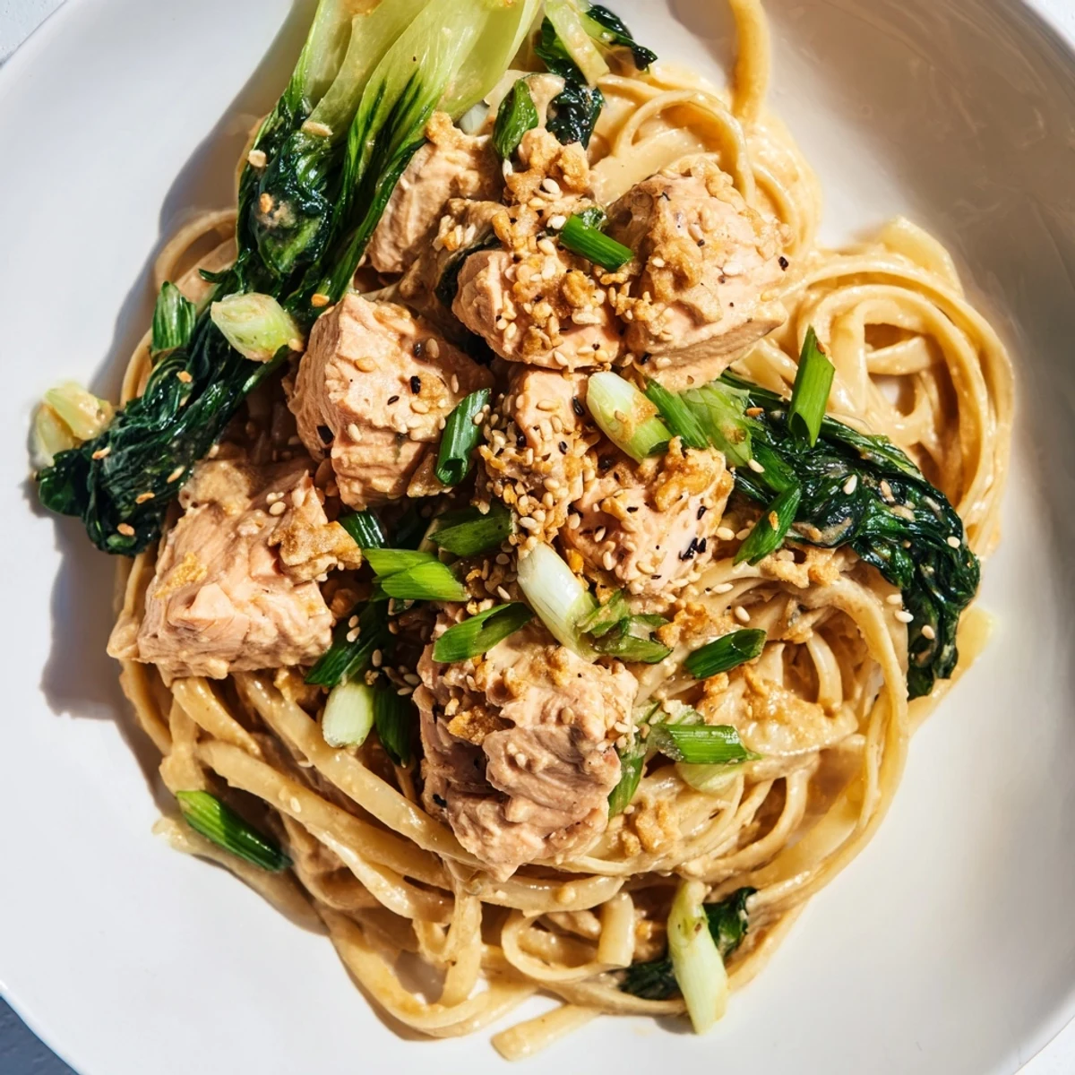 A savory plate of Miso Butter Salmon Pasta, combining fresh bok choy with a rich, creamy sauce.