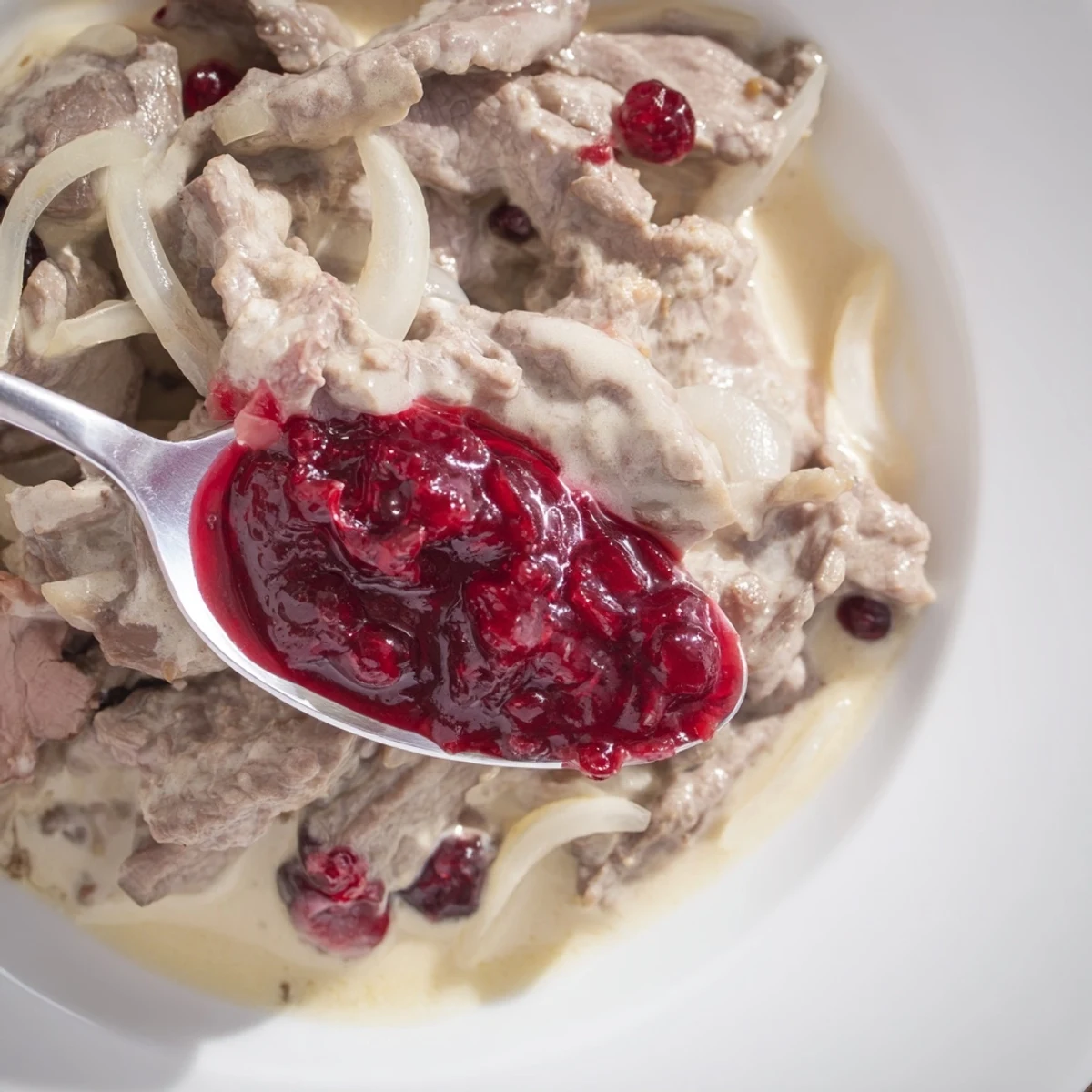 Tender slices of reindeer meat simmer in Finnish Reindeer Stew, served with creamy potatoes for a hearty meal.