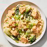 Golden-brown Miso Butter Salmon Pasta, the salmon flaked over the linguine, ready to serve with scallions.