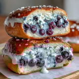 Wholesome blueberry protein bagels topped with tangy Greek yogurt frosting, ideal for a healthy breakfast or post-workout snack.
