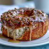 A tray of golden lemon poppy seed protein bagels with a glossy lemon glaze, perfect for a healthy breakfast or snack.