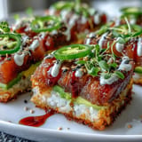 Viral appetizer perfection: Spicy Tuna Crispy Rice Bites with a spicy drizzle.