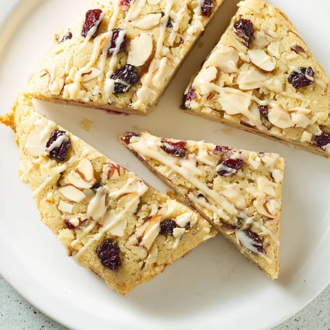 Golden-brown Cherry Almond Shortbread Wedges, drizzled with sweet almond glaze, ready for dessert.