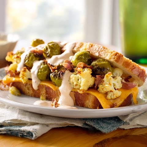 Crispy Buffalo Cauliflower Ranch Grilled Cheese, golden, oozing cheese, and flavorful buffalo cauliflower aroma.