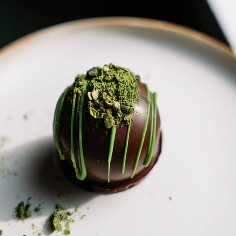 Vibrant green Matcha Dark Chocolate Peppermint Truffles, dusted with matcha, a beautiful dessert treat.