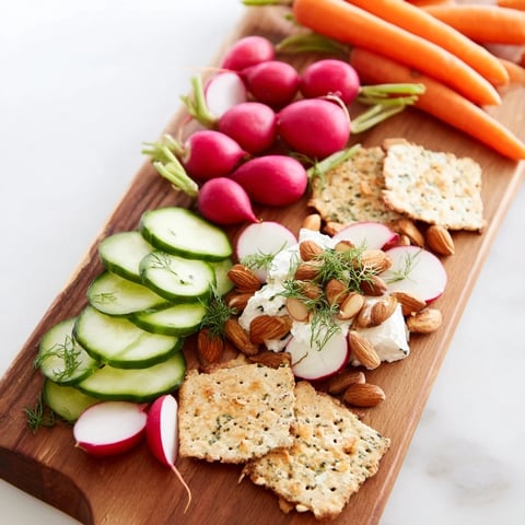 Elegant "Zen Balance" appetizer board featuring goat cheese, crisp veggies, and gluten-free crackers.