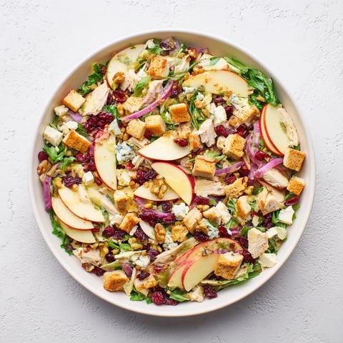 Chicken and Apple Winter Salad, a colorful mix of apples, chicken, and pecans, looks fresh and inviting.