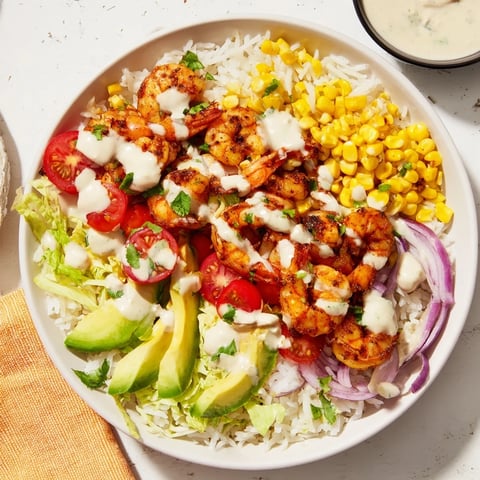 Tempting Cajun Shrimp Taco Bowls, overflowing with colorful veggies, flavorful shrimp, and creamy sauce, ready to enjoy.