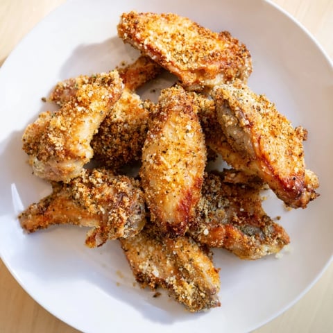 Golden-brown baked Parmesan chicken wings, a crispy and savory appetizer perfect for game day.