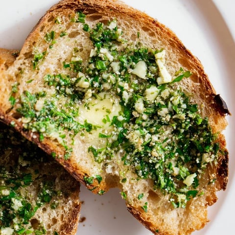 Golden slices of Herb Butter Toast glisten with melted, herb-flecked butter and a dusting of flaky salt.
