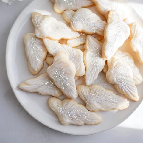 Close-up of baked Angel Wings sugar cookies, showing light, buttery texture and festive presentation.