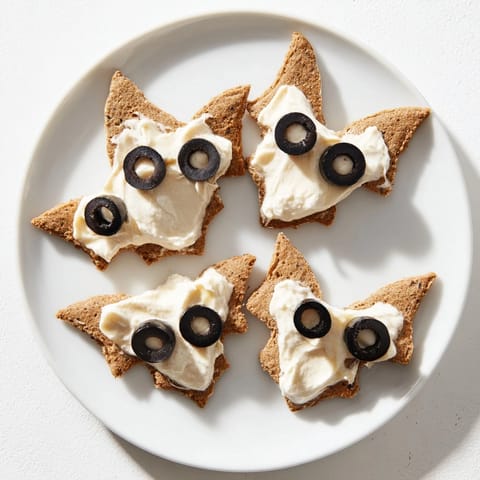 A large, colorful Flying Bat Halloween Snack Board overflowing with sweet and savory treats.