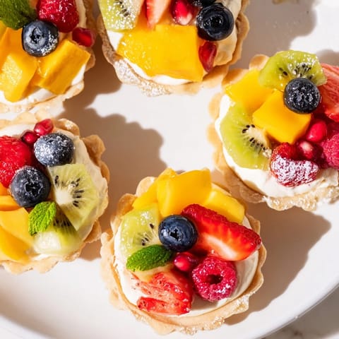 Heart Shaped Fruit Tart Board arranged with colorful berries and creamy filling, perfect for a romantic dessert.