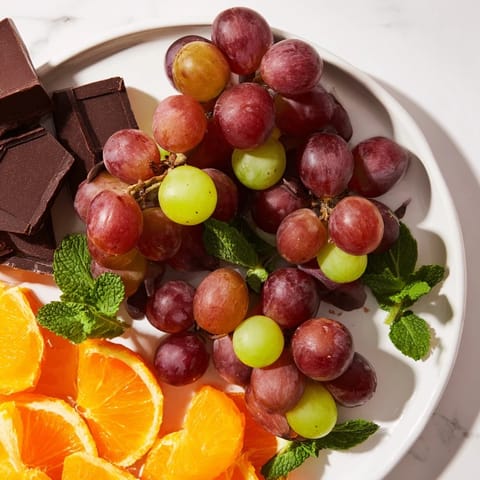 This Grapes of Fortune Dessert Board features colorful grapes, cheeses, and crackers ready for celebration.