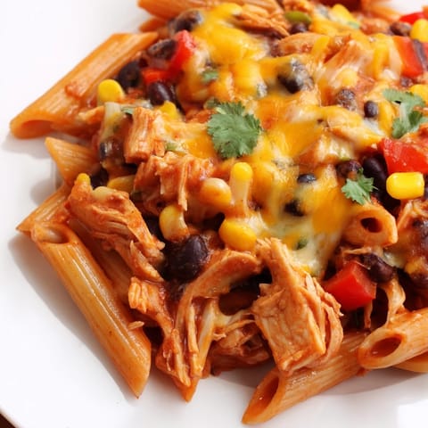 Golden melted cheese topping the Chicken Enchilada Pasta, with black beans and corn peeking through the creamy Tex-Mex inspired sauce.
