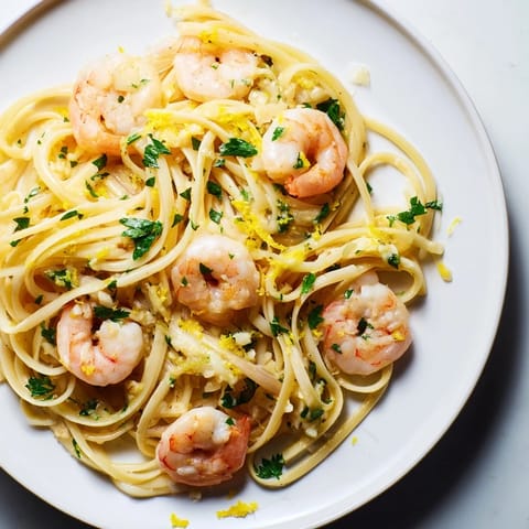 A close-up of Garlic Butter Shrimp Linguine featuring tender seafood, melted butter, and a hint of lemon zest.  