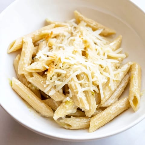 Caesar Pasta Chicken Bowl served warm, garnished with shaved Parmesan and cherry tomatoes for a fresh, balanced main dish.  