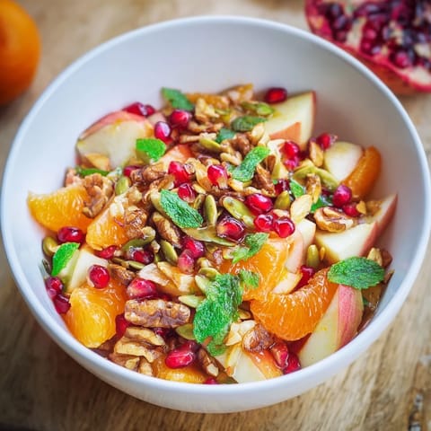 This fresh Pomegranate and Walnut Salad combines juicy orange segments and ripe pear with a sprinkle of cinnamon and mint.