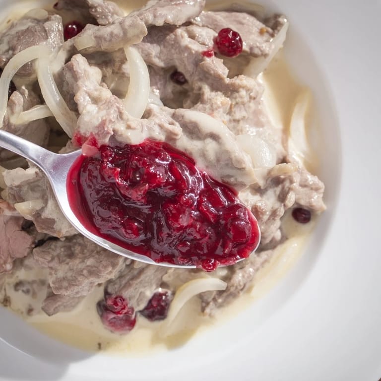 Tender slices of reindeer meat simmer in Finnish Reindeer Stew, served with creamy potatoes for a hearty meal.