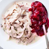 A steaming bowl of Finnish Reindeer Stew, rich and savory, ready to be enjoyed with lingonberries.