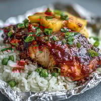 Grilled Pineapple Chicken and Rice Foil Packets with colorful vegetables and sweet pineapple chunks.